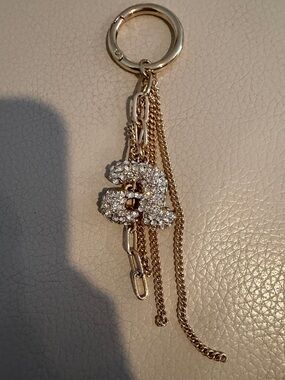 A Gold-Tone Crystal Keychain Charm - Interlocking Double Design